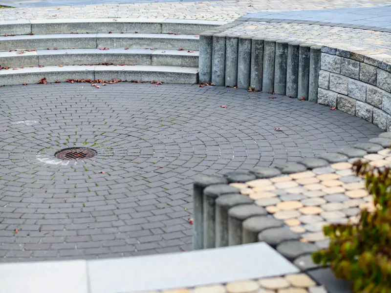 Curved paved seating area with stone steps
